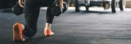 woman training with weights at the gym