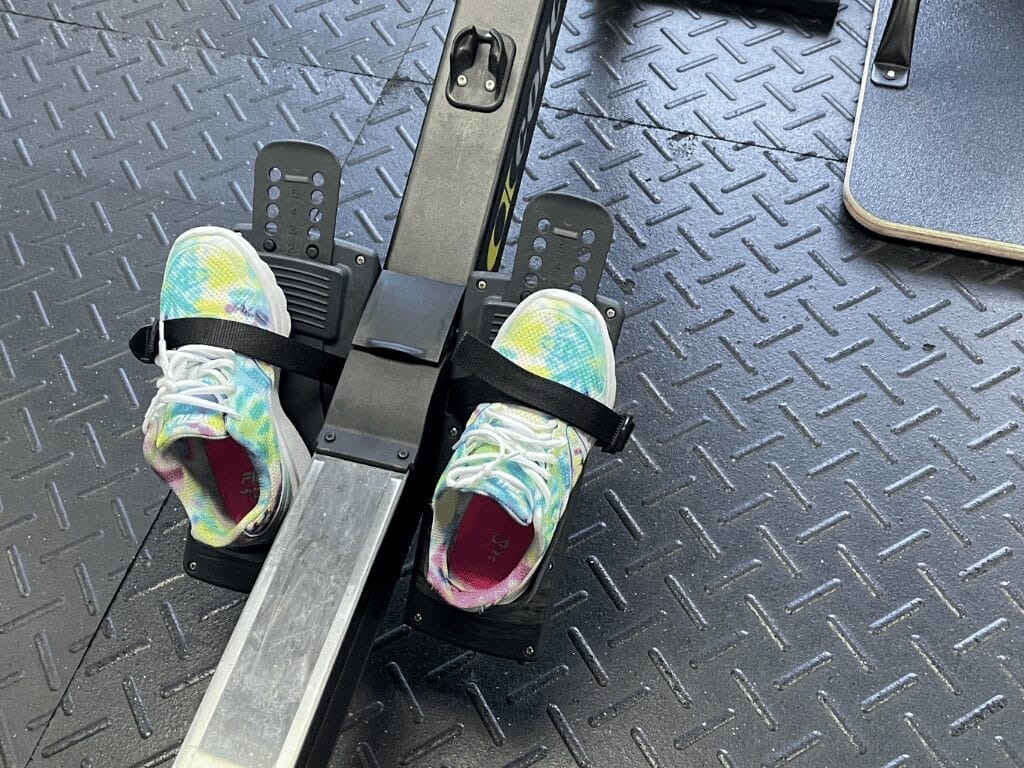 Someone that dislikes cardio left their shoes inside the foot straps of a rowing machine
