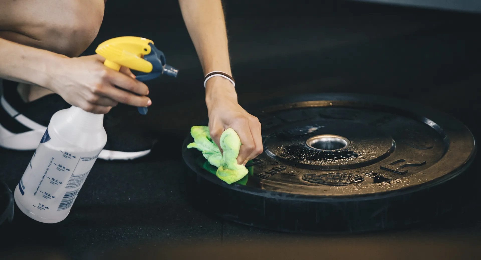 Man cleaning gym equipment